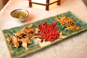 Three piles of colorful, effective dried herbs on a rectangular platter.